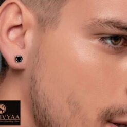 model wearing -Men's black solitaire diamond earring, gold finish, 4-prong basket setting