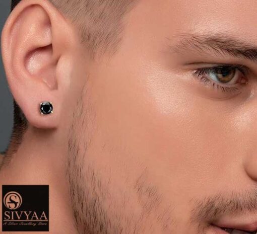 model wearing -Men's black solitaire diamond earring, gold finish, 4-prong basket setting