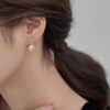 model wearing -gold finish SIVYAA Fresh Water Pink Pearl Tiny Drop Dangle pure silver Earrings