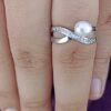 model wearing -SIVYAA White Fresh Water Pearl & Cubic Zirconia pure silver Criss-Cross Finger Ring