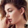 female model wearing- SIVYAA Kaju Shape flower textured pure silver bali
