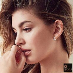 female model wearing- SIVYAA Kaju Shape flower textured pure silver bali