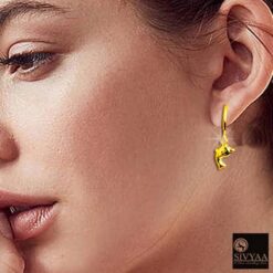 SIVYAA model wearing- gold dolphin charm silver hoop bali