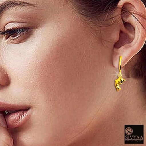 SIVYAA model wearing- gold dolphin charm silver hoop bali