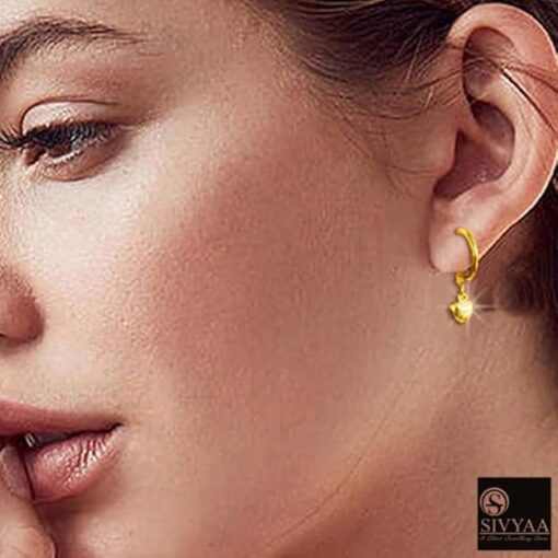 SIVYAA model wearing-gold heart charm silver hoop bali