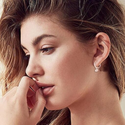 SIVYAA model wearing- heart charm drop Textured Round Silver hoop