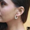 model wearing 2-925 sterling silver oxidized crescent tribal hoop earrings with filigree central design