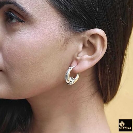 model wearing 2-925 sterling silver oxidized crescent tribal hoop earrings with filigree central design